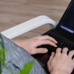person using black Asus laptop