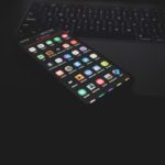 black iphone 5 on black computer keyboard