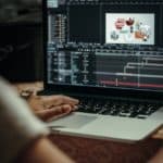 person using macbook pro on table