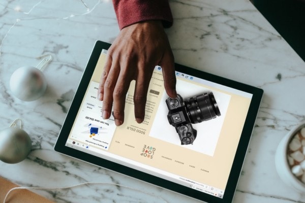 Overhead view of a person clicking on a Surface laptop with wrapping presents around